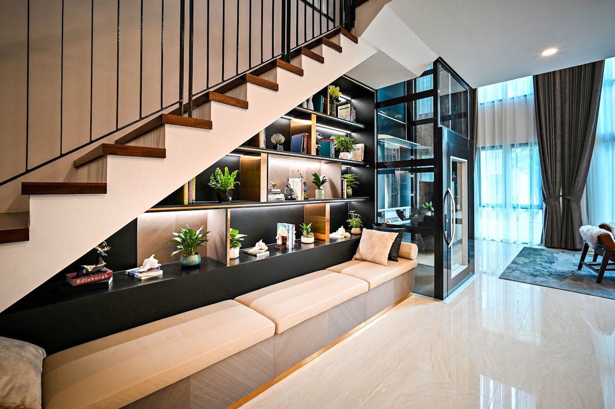 Real fitted under-stairs project with bench seating, lit shelving and tucked storage built into the stair void.
